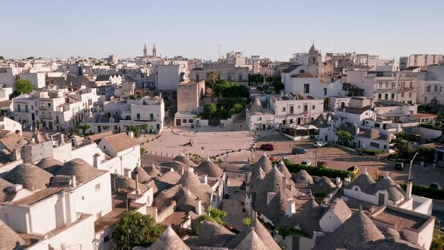 Aerial view of trulli of alberobello town in Italy. drone fly over old town buildings at sunrise
