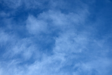 Blue skies strewn with clouds. Dawn sky with white clouds. White clouds against the blue sky.
