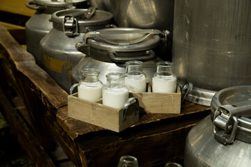 Milk in retro bottles, aluminum cans, straw.