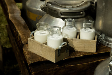 Milk in retro bottles, aluminum cans, straw.