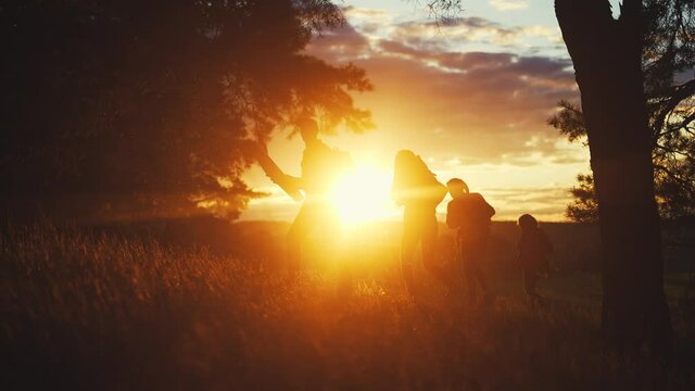 hiker group. team of hikers with backpacks silhouette walk through the forest. nature travel adventure a concept. hiker group with backpacks walk on the sunset. mountain outdoor lifestyle view