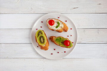 Three mini sandwiches on a plate