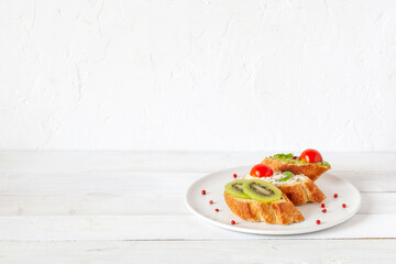 Three mini sandwiches on a plate