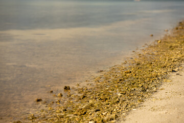 Long exposure photo waves crashing on rocks smooth water surface
