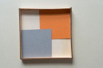 Fototapeta premium paper squares inside a wooden box