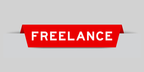 Red color inserted label with word freelance on gray background