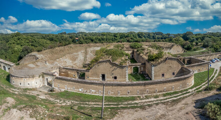 Fortifications encircling Komarno in Slovakia with bomb safe shelters, loopholes, casemated gunports blue cloudy sky background 