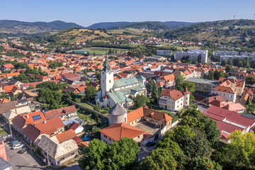 Fototapeta na wymiar Aerial panoramic view of Krupina small medieval town in Southern Slovakia with traces of medieval city wall between modern block houses and old buildings, bastion turned outdoor movie theater cinema