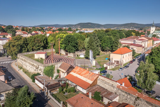 Aerial panoramic view of Krupina small medieval town in Southern Slovakia with traces of medieval city wall between modern block houses and old buildings, bastion turned outdoor movie theater cinema