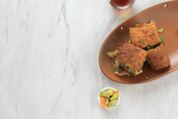 Martabak Telur is Popular Street Food in Indonesia. Egg, Spring Onion Wrapped with Thin Flour Batter