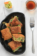 Martabak Telur is Popular Street Food in Indonesia. Egg, Spring Onion Wrapped with Thin Flour Batter