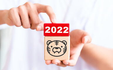 The Year of the Tiger.Happy New year 2022. The year of the tiger of lunar chinese calendar.Creative tiger logo and number 2022 on a block background.Greeting Card .Asian culture.Japan.zodiac animals.