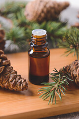 Bottle of coniferous essential oil on table