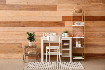 Stylish workplace with alarm clock in interior of room