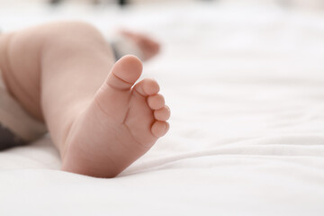 Adorable baby leg on bed, closeup
