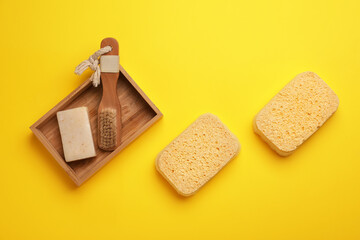 Bath sponges, soap and brush on color background