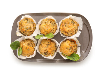 Baking tin with tasty spinach muffins on white background