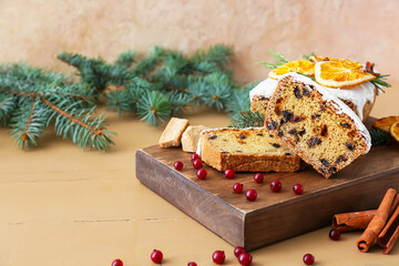 Board with tasty Christmas stollen on table