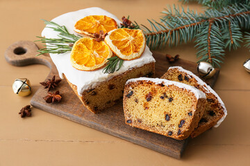 Board with tasty Christmas stollen on table