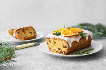 Plate with tasty Christmas stollen on grunge background