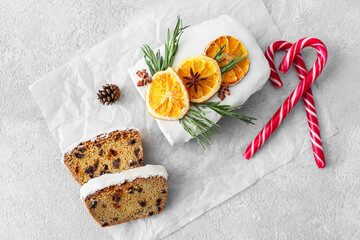 Tasty Christmas stollen on grey background