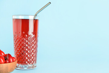 Glass of healthy dogwood berry drink on color background © Pixel-Shot