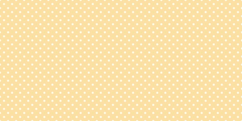 White polka dot pattern abstract on light yellow background.
