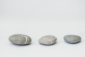Stones is on the light background, simple poise stones. Purity harmony and Balance Concept. Stone podiums.
