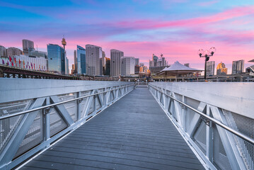 Sydney Tower Eye, View of Sydney skyline from Darling Harbour Bridge with colourful sunrise sky...