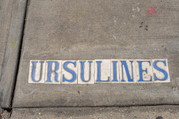 Ursulines Street Tile Inlay on Sidewalk in French Quarter of New Orleans, Louisiana, USA	