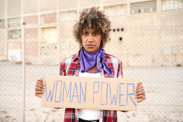 Woman holding a sign Women Power. Nationwide women's strike.
