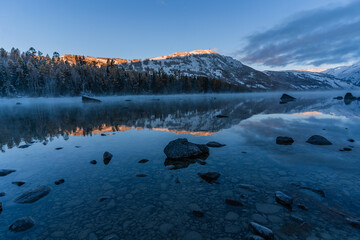 The winter landscape of Kanas lake in Xinjiang province, China, at sunrise. - obrazy, fototapety, plakaty