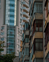 Obraz premium old block-panel residential building next to the new one 