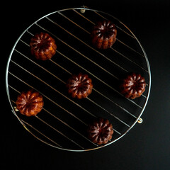 Close up image of  canelé with black background