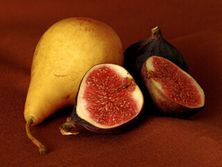 pear and figs lie on a black background