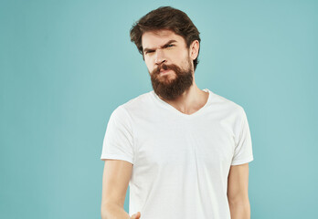Fototapeta premium emotional man in a white t-shirt hand gestures anger Lifestyle