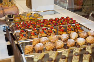 Fruit Pastries with Strawberries and Black Cherries and Savory Sandwiches with Cold Cuts