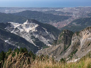 View of the marble Quarries of Carrara, the paths carved into the side of the mountain and the town...