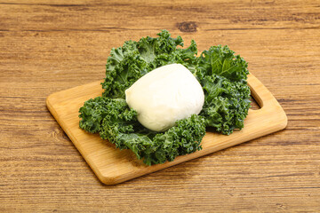 Soft mozzarella cheese over board