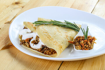 Pancake with minced meat and sauce