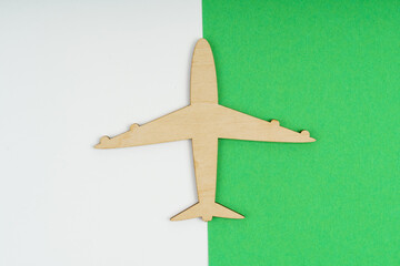 Wooden model airplane on white green background.