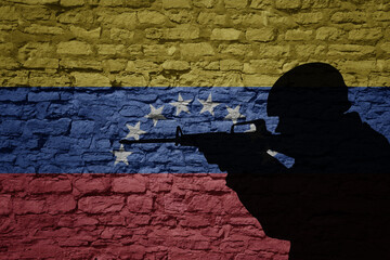 Soldier silhouette on the old brick wall with flag of venezuela country.