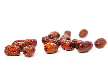Dried Chinese dates isolated on white background. Close up of dried Chinese red dates or jujube. Selective focus.