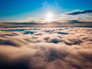 High flight over the fog in the mountains. Ukrainian Carpathians in the morning. Aerial drone view.