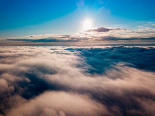 Fototapeta premium High flight over the fog in the mountains. Ukrainian Carpathians in the morning. Aerial drone view.