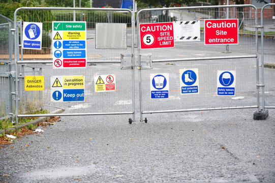 Construction site health and safety message rules sign board signage on fence boundary