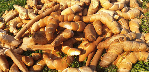 Background of discarded bread on the ground. Panorama.