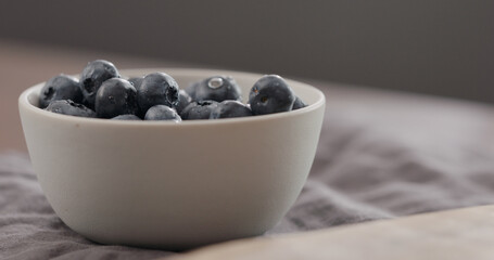 washed ripe blueberries in white bowl wit copy space
