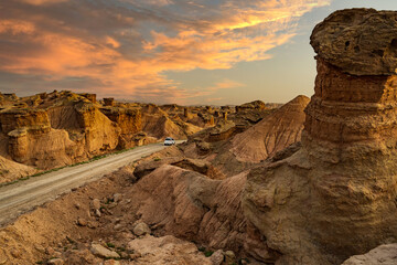 long road in sandstone mountains in Xinjiang, China