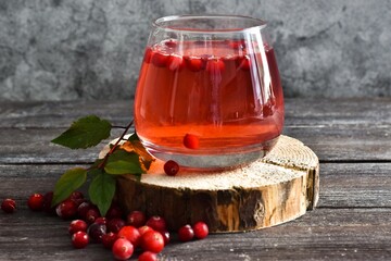 Glass Refreshing cocktail and mint on Round wooden saw cut cylinder shape on a brown wooden table. Selective focus